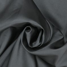 Elevate your creations with our exquisite Black Solid Mikado fabric. Renowned for its luxurious sheen and structured finish, Mikado is a blend of silk and nylon that offers both elegance and versatility. The deep, rich black hue adds an element of sophistication to any garment, making it a popular choice for eveningwear, bridal gowns, and formal attire. This fabric's substantial weight and crisp texture provide the perfect drape, ensuring that your designs maintain their shape and elegance throu Elegant Silk Fabric For Evening, Elegant Evening Silk Fabric, Elegant Silk Fabric For Formal Occasion, Elegant Black Party Fabric, Elegant Silk Fabric With Satin Finish, Fitted Solid Color Fabric For Formal Occasions, Fitted Solid Fabric For Formal Wear, Formal Solid Fitted Fabric, Fitted Silk Fabric For Party