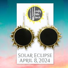 the earrings are black and gold with sun design on them, as well as an ad for crafty little birch