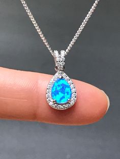 Sterling Silver White Blue Opal and CZ Necklace Bridal/Wedding Opal Necklace Metal: All Components Are Made From .925 Sterling Silver Stone: Lab created Opal and Cubic Zirconia Measurement: pendant height is 20mm including bail Choose Chain Length Please feel free to Convo me with any questions before purchasing. Please view policy before purchasing Other Opal Necklaces can be found here https://www.etsy.com/shop/LinksAndStones?ref=ss_profile&section_id=24284450 Thank You For Visiting My Sho Blue Opal Dainty Necklace, Blue Opal Round Necklace, Handmade Blue Opal Necklaces, Pear-shaped Opal Necklaces For Gifts, Opal Necklaces, Nickel-free Blue Opal Jewelry, Blue Fire Opal, October Birthstone Jewelry, Fire Opal Necklace