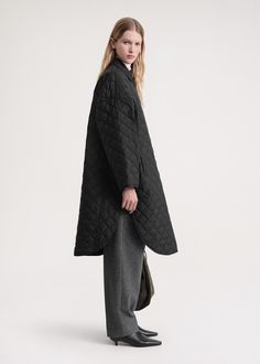 Inspired by TOTEME's quilted jacket, this coat has an architectural cocoon shape with a curved, knee-grazing hem. The crunchy recycled-polyester shell is water-repellent and finished with welt pockets and press buttons that open to a neat interior lined in the same fabric. Layer it over everyday looks. Oversized Quilted Jacket For Workwear, Oversized Black Quilted Outerwear, Oversized Quilted Jacket For Fall Workwear, Quilted Long Coat For Fall, Oversized Quilted Jacket For Winter Workwear, Black Inspiration, Cocoon Coat, Green Coat, Quilted Coat