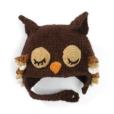 a crocheted owl hat with eyes and ears on it's head is shown