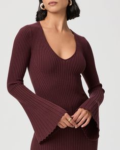 This long sleeve v-neck sweater dress is made from an incredibly soft and comfortable oxblood red ribbed knit material with a flattering contour stitch detail throughout. With a classic a-line silhouette and bell sleeves, the Bel Dress can be worn from day to night. | Bel Dress - Oxblood | Size XL Fitted Ribbed V-neck Sweater With Long Sleeves, Fitted V-neck Sweater With Ribbed Cuffs For Fall, Fitted Ribbed V-neck Sweater, Elegant Stretch Ribbed V-neck Sweater, Ribbed Stretch V-neck Sweater, Fitted V-neck Top With Ribbed Cuffs, Burgundy V-neck Sweater For Fall, Oxblood Red, Ribbed Sweater Dress