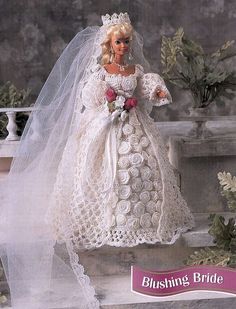 a barbie doll wearing a wedding dress and veil