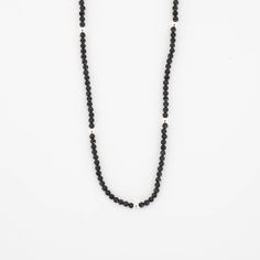 This beautiful Obsidian Beaded Necklace is edgy. elegant, and eye-catching, making it perfect for wearing by itself or layered with a simple chain necklace. The strand of pearls is punctuated with your choice of gold or silver beads for added interest. Note: We reinforce the necklace’s center silk cord with hidden knots—if your necklace breaks, most of the beads will remain intact and unaffected. For maximum life, we recommend you do not wear this necklace in water or during any rigorous activit Minimalist Everyday Pearl Necklace With Beaded Chain, Everyday Minimalist Pearl Necklace With Beaded Chain, Single Strand Necklaces With Round Beads For Layering, Black Minimalist Necklace With Gemstone Beads, Minimalist Black Gemstone Beads Necklace, Minimalist Everyday Necklace With Gemstone Beads, Minimalist Single Strand Beaded Necklace, Classic Black Pearl Chain Necklace, Minimalist Beaded Onyx Jewelry