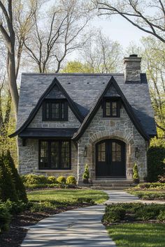 a stone house with black trim and windows