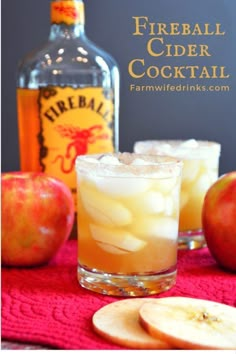 an apple cider cocktail is garnished with apples