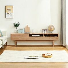 a living room with a white couch and wooden furniture