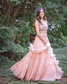 A frilled pink skirt paired with a unique scallop-edge blouse. It is paired with a ruffle dupatta. DELIVERY TIME Please allow 8-12 weeks for your outfit to arrive. FABRIC DETAILSCrepe. Professional cleaning only. Frilled Lehenga, Sekrit Theater, Ruffle Lehenga, Engagement Looks, Ruffle Dupatta, Halter Blouse, Net Lehenga, Pink Lehenga, Different Shades Of Pink