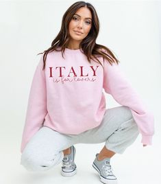 Get ready to be OBSESSED with your new favorite Italians Is For Lovers Sweatshirt! This super soft crewneck is the cutest and most trendy way to emit all those Italian American vibes! This is the perfect sweatshirt to throw on for a cozy valentines day with your partner! Also makes a great gift! This design is an original, created by Jackie Bonsignore @ Drift East Designs. She uses digital design elements and collage. She optimizes each image or illustration for a crisp, clear and gorgeous print onto a variety of apparel.  * Q U I C K * F A C T S * ✺ This is a Gildan 1800 crewneck, known for its warmth and softness. It's the perfect piece for cool weather and layered outfits! ✺ 50/50 cotton/polyester ✺ Wash and dry normally (on cool for best results) ✺ Please note that colors of the shirt Logo Print Crew Neck Sweater For Loungewear, Crew Neck Sweater With Logo For Loungewear, Logo Print Crew Neck Tops For Loungewear, Crew Neck Tops With Logo Print For Loungewear, Crew Neck Loungewear Tops With Logo Print, Pink Crew Neck Top With Letter Print, Pink Slogan Crew Neck Sweater, Pink Slogan Sweater Crew Neck, Pink Crew Neck Sweater With Slogan