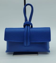 Dimensions: Width: 9"x  Height: 5"x Depth: 2", Loop Handle Length: 4" drop, Strap Length: 22" drop Genuine Leather Shoulder Bag (Origin: Florence, Italy) in Electric Blue *Pebble Grain Calf Leather *Flap Closure  *Inside Zip Pocket *Adjustable Shoulder Strap *Dust Bag Included Blue Crossbody Evening Bag For Formal Occasions, Modern Blue Evening Bag, Blue Crossbody Clutch For Evening, Blue Mobile Phone Evening Bag, Blue Evening Bag With Top Handle And Removable Pouch, Blue Travel Clutch With Mobile Phone Bag, Blue Clutch With Mobile Phone Bag For Daily Use, Blue Satchel Evening Bag For Travel, Blue Shoulder Evening Bag With Detachable Strap