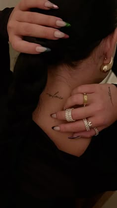 a woman with two rings on her neck and one ring in the other's hand