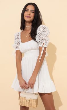 Strut your stuff in this oh so adorable princess dress. The Shay will have all eyes on you due to the lace puff sleeves, square neckline and flared skirt. Made in our white chiffon fabric. Pair with white sneakers or nude heels for a day to night look we are loving. 
	 
	Made in Los Angeles
	 
	- 100% Polyester 
	- Fully Lined 
	- Hand Wash Cold 
	 
	Length of Dress 31in/78.7cm 
	All Measurements Are For A Size Small Chic Lace Puff Sleeve Dress For Summer, Feminine Lace Puff Sleeve Dress For Summer, White Puff Sleeve Mini Dress With Lace Trim, Cute White Puff Sleeve Dress For Spring, White Lace Puff Sleeve Dress With Lace Trim, Feminine White Mini Dress With Lace-up Back, Cute White Lace Mini Dress, White Puff Sleeve Dress With Ruffles For Brunch, White Flowy Puff Sleeve Dress For Summer