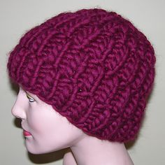 a mannequin head wearing a purple knitted hat