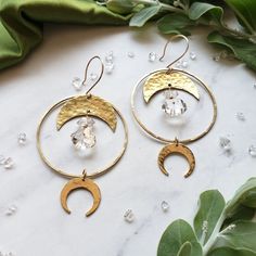 Halo Quartz Moon Hoops Earrings Shop Dreamers of Dreams Everyday Brass Jewelry With Natural Stones, Handmade Artisan Moon-shaped Jewelry, Bohemian Moon Shaped Brass Jewelry, Bohemian Hand Forged Jewelry For Everyday Wear, Bohemian Hand Forged Jewelry For Everyday, Bohemian Hand Forged Everyday Jewelry, Everyday Bohemian Hand Forged Jewelry, Nickel-free Half Moon Bohemian Jewelry, Bohemian Brass Earrings With Moon Phase Detail