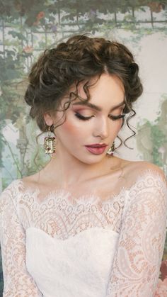 a woman with curly hair wearing a white lace dress and holding her hands in her pockets