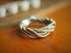 a silver ring sitting on top of a wooden table