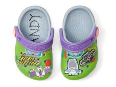 a pair of purple and green children's shoes with cartoon characters on the front