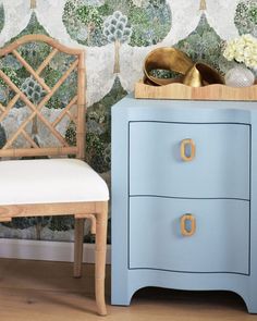 a blue dresser next to a white chair