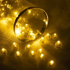 a bunch of lights that are on top of a table with some glass balls in front of them