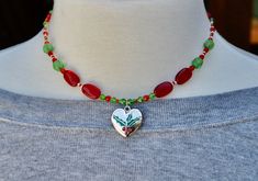 Christmas holly beaded red and green necklace/Christmas tree necklace/silver heart pendant with Christmas holly/handmade jewelry/Mom gift Beaded Jewelry Christmas Gift, Beaded Jewelry For Christmas Gift, Christmas Beaded Jewelry Gift, Handmade Round Beads Jewelry For Holiday, Silver Beaded Necklace With Heart Charm As Gift, Silver Beaded Necklaces With Heart Beads For Gift, Handmade Jewelry For Holiday Gifts, Silver Beaded Necklace With Heart Beads For Gift, Handmade Jewelry For Holiday Season