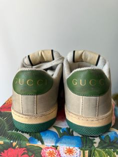 Authentic Gucci Screener Sneakers in excellent condition. Worn once but they don't fit me, sadly. Size 37, fit like a US 7.5. Classic Gucci sneakers featuring the Gucci stripes and classic green sole with bee design. Made in Italy. Please note: this style has some intentional distressing. Approximate measurements.Heel to toe: 10.5"Width: 3.75" Luxury Green Sneakers With Branded Insole, Green Sneakers With Embroidered Logo And Round Toe, Green Round Toe Sneakers With Embroidered Logo, Green Low-top Sneakers With Embroidered Logo, Luxury Green Low-top Sneakers, Green Luxury Low-top Custom Sneakers, Vintage Low-top Sneakers With Embroidered Logo, Designer Green Low-top Custom Sneakers, Designer Green Lace-up Sneakers