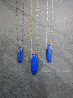 Lapis Lazuli stone, polished and on a custom length chain in you choice of: Gold Filled, Sterling Silver or Gunmetal finish. Select from four different pendant sizes. Lapis Lazuli is a powerful crystal for activating the higher mind and enhancing intellectual ability. It stimulates the desire for knowledge, truth and understanding, and aids the process of learning. It is excellent for enhancing memory. Lapis Lazuli is a stone of communication that can bring truthfulness, openness, and mental cla Blue Sterling Silver Cable Chain Jewelry, Blue Pendant Necklace With Cable Chain, Blue Long Drop Necklace As A Gift, Blue Long Drop Necklace As Gift, Blue Cable Chain Necklace For Gifts, Blue Long Drop Necklace For Gift, Minimalist Blue Necklace With Rectangular Pendant, Blue Cable Chain Jewelry As A Gift, Handmade Blue Necklaces With Long Drop Shape