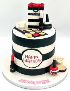 a birthday cake with makeup and lipstick on it's top tier is decorated in black and white stripes