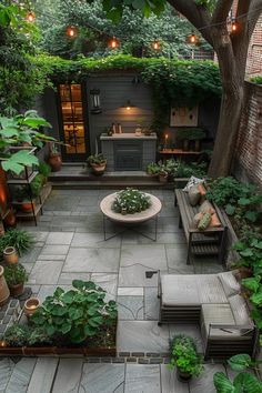 an outdoor patio with seating and potted plants in the center, surrounded by greenery