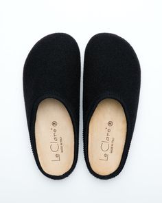 Description: The Nebraska Clog in black is an Italian take on a European classic. The Nebraska is one of the most versatile clog style slippers available. From home to the office to weekend, the minimalist design of these clogs will take you anywhere in comfort. The anatomical self-molding latex and thermoforming cork insole provide a firm customized comfort, and the insole is completely removable for cleaning. LeClare Slippers are exclusively handcrafted in our small-batch factory in Treviso, I Modern Black Slippers With Rubber Sole, Black Modern Slippers With Rubber Sole, Comfortable Black Slip-on Clogs, Classic Black Slip-on Slippers, Classic Black Slippers With Rubber Sole, Modern Black Slip-on Slippers, Modern Black Mules With Cushioned Footbed, Black Slippers With Removable Insole And Closed Toe, Classic Black Cushioned Slippers