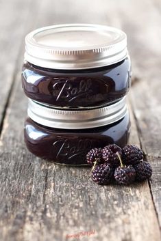 black raspberry jam in a mason jar with berries on the side and text overlay that reads, black raspberry jam