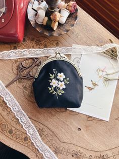 Carry Elegance with you with the Floral Embroidered Vintage Wallet! 💜 Christmas Eve Box Fillers Add timeless elegance to your accessory collection with this handmade coin purse and store your small items in style. Both practical and artistic, this unique piece will add value to your daily life. Features: - Handmade with Love: Each wallet is carefully handcrafted, so no two pieces are exactly alike. - Elegant Embroidery: Delicate purple floral embroidery gives the wallet a feminine and vintage c Embroidery Wallet, Wallet Embroidery, Embroidered Wallets Perfect For Gifts, Embroidered Pouch, Elegant Floral Embroidery Pouch For Gift, Elegant Floral Embroidered Pouch For Gift, Everyday Embroidered Wallets, Elegant Floral Embroidery Pouch Gift, Festive Floral Embroidered Pouch Bag