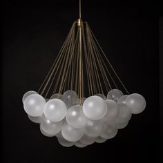 a chandelier with white balloons hanging from it