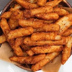 a basket filled with french fries sitting on top of a table