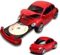 a red toy car on top of a white table next to another toy car that is in the shape of a bed