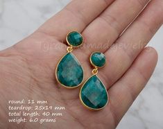 This pair of two tier genuine gemstone (emerald) earrings would be a great reward for your self or a great gift for your mother or best friend. Each one has two tiers of natural stones:1. top tier: a small (11mm) round emerald in gold bezel2. bottom tier: a large pear shaped emerald (natural gemstone) stone (about 25 x 19 mm) set in gold bezel    Note: other stone combinations available. Please inquire.3. earring total length ~ 40 mm4. bezel material: 24k gold plated5. earring wire: 24k gold pla Emerald Earring, Sapphire Earring, Emerald Earrings Drop, Pear Earrings, Engraved Locket, Emerald Green Earrings, Sterling Silver Locket, Earring Wire, Earring Drop