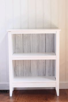 a white book shelf with flowers on top