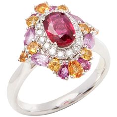 This ring designed by David Jerome is from his private collection and features one oval cut Ruby sourced in Mozambique. Set with a mix of round brilliant cut Diamonds, pink and yellow Sapphires totalling 1.70cts combined. Mounted in platinum. Ring size UK N, EU size 54, USA size 6 1/2. David prides himself in only sourcing the finest and most exclusive gemstones whose natural beauty and colour enhance the settings he creates for each piece. These exclusive designs offer buyers a unique opportuni Dazzling Oval Multi-stone Cluster Ring, Multicolor Oval Diamond Ring For Formal Occasions, Multicolor Oval Sapphire Ring With Diamonds, Oval Multicolor Cluster Ring Fine Jewelry, Oval Pink Sapphire Diamond Ring With Accent Stones, Oval Ruby Ring With Brilliant Cut Pink Sapphire, Formal Multicolor Oval Diamond Ring, Luxury Pink Oval Cluster Ring, Multicolor Oval Sapphire Ring For Formal Occasions