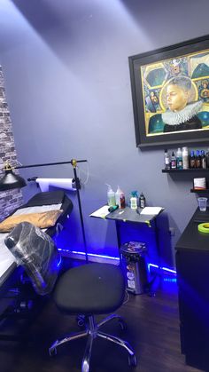 a salon room with blue lighting and black chairs