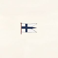 an airplane flying in the sky with a flag on it