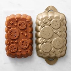 two cookie pans sitting next to each other on top of a white countertop