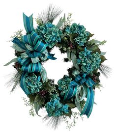 a wreath with blue flowers and green leaves