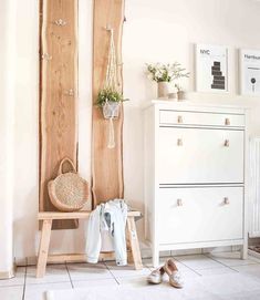 a white room with two wooden doors and some shoes on the floor next to it