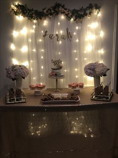 a table with desserts and lights on it