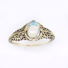 This is a solid 14k yellow gold ring with a beautiful natural crystal opal prong set in a Victorian ring setting. The oval opal cabochon is 6 x 4mm and has bright flashes of green, blue and orange fire. The type of opal is a solid Australian opal that is named crystal opal because of its crystal like transparency. The ring setting is a reproduction of a Victorian ring that has fine filigree details. Custom made to order. Please message me if you would like to choose the opal or a different gemst Antique Style Opal Ring For Formal Occasions, Yellow Gold Opal Ring In Fine Jewelry Style, Formal Yellow Gold Ethiopian Opal Ring, Heirloom White Opal Birthstone Ring, Antique Style Round Opal Ring, Heirloom 14k White Gold Opal Ring, Vintage Opal Rings In Yellow Gold, Classic Yellow Gold Opal Ring, White Gold Opal Ring In Fine Jewelry Style