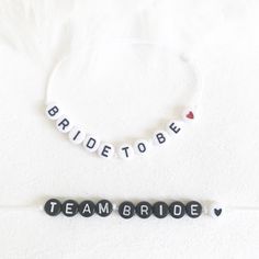 "Follow us on Instagram @ohlala_london for more ideas, and contact us for custom orders: everything is possible! Bracelets made to order - sent within 24h. One bracelet will remain the same \"the Bride to be\" and then you can select as many bracelets as you want for each one of your \"tribe\"!! Perfect for a hen do party or to give to your bridesmaids. Bracelets are made on white cotton braid. \"Bride to be\" on white beads and Black letters and the \"Team Bride\" with black beads and white letters.  If you want a specific colour for the braid, or change the wording, just add it in the personalisation box. I'm here if you have any questions. ✨Made of: high-quality acrylic resin, strong and durable. ✨Size: The size of the letter beads is about 4*7 mm, and the hole diameter is about 1 mm. ✨ Bachelorette Beaded Bracelets, Bracelet Team Bride, Letter Bead Bracelets, Hen Party Favours, Bride Bracelet, Baby Birthday Gifts, Engagement Presents, Halloween Bracelet, Team Bride