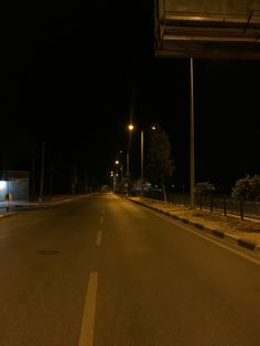 an empty street at night with no cars on it