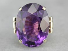 This is a stunning stone, with a rich color and a sophisticated cut. This natural, well-cut amethyst at the center glimmers with its medium-deep eggplant purple color that flashes with pops of violet and raspberry. We've set this pretty gem into a vintage mounting of yellow gold. Easy to wear, this sits comfortably on the finger and is a nice, bold size that is sure to make a statement! Metal: 14K Yellow Gold Gem: Amethyst 19.50 Carats Gem Measurements: 15.9 x 20.8 mm, Oval Ring Size: 5.50 Marks Faceted Purple Amethyst Ring For Formal Occasions, Formal Amethyst Ring With Large Stone, Formal Faceted Purple Amethyst Ring, Oval Purple Amethyst Ring With 17 Jewels, Classic Large Stone Amethyst Ring For Formal Events, Purple Faceted Ring For Formal Occasions, Classic Formal Amethyst Ring With Large Stone, Formal Faceted Amethyst Ring, Formal Faceted Purple Ring