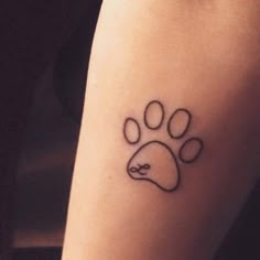 a dog paw tattoo on the arm