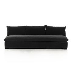 a black couch sitting on top of a white floor