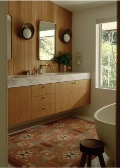 a bathroom with two sinks, mirrors and a bathtub in the middle of it